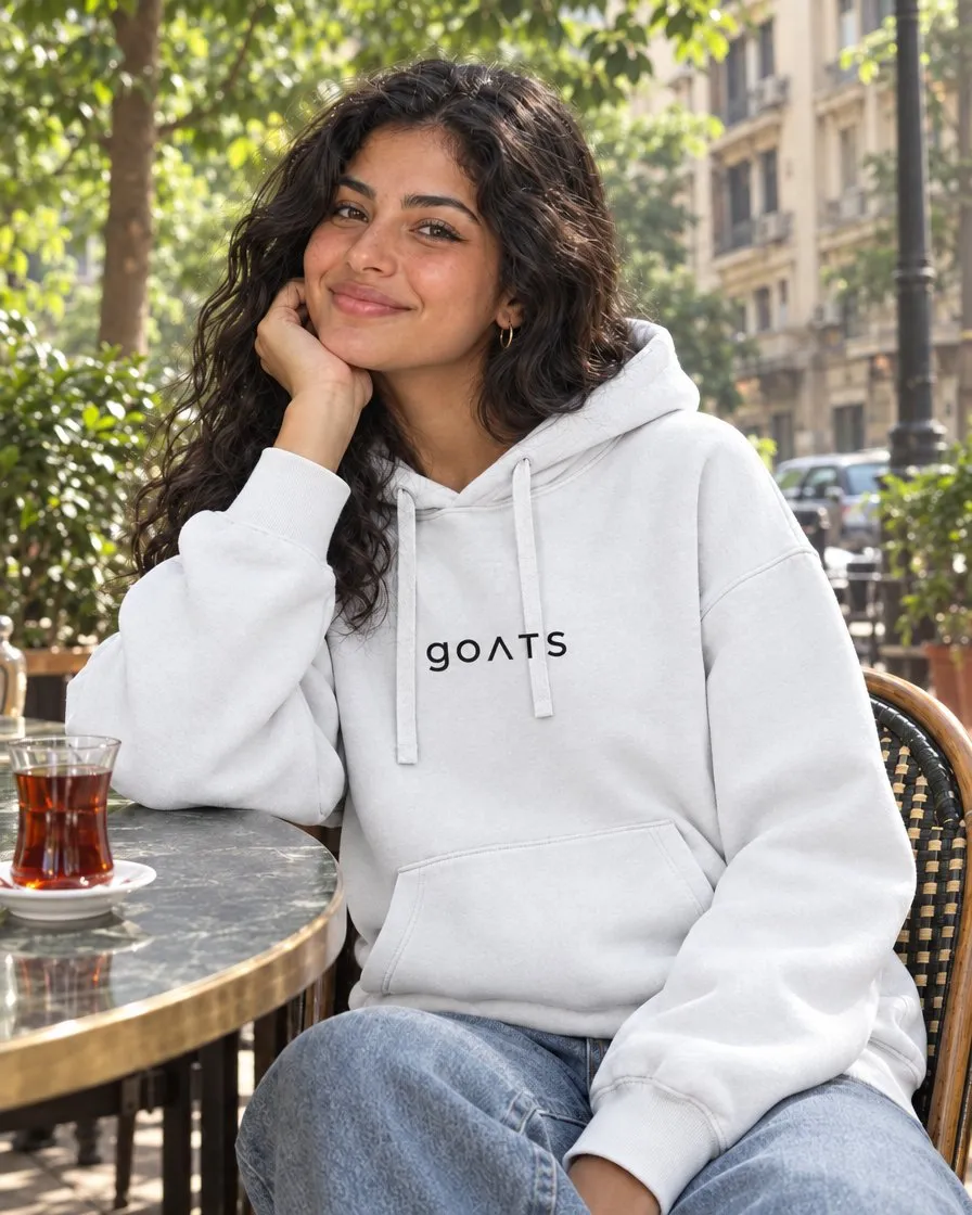 White GOATS hoodie at a Cairo cafe